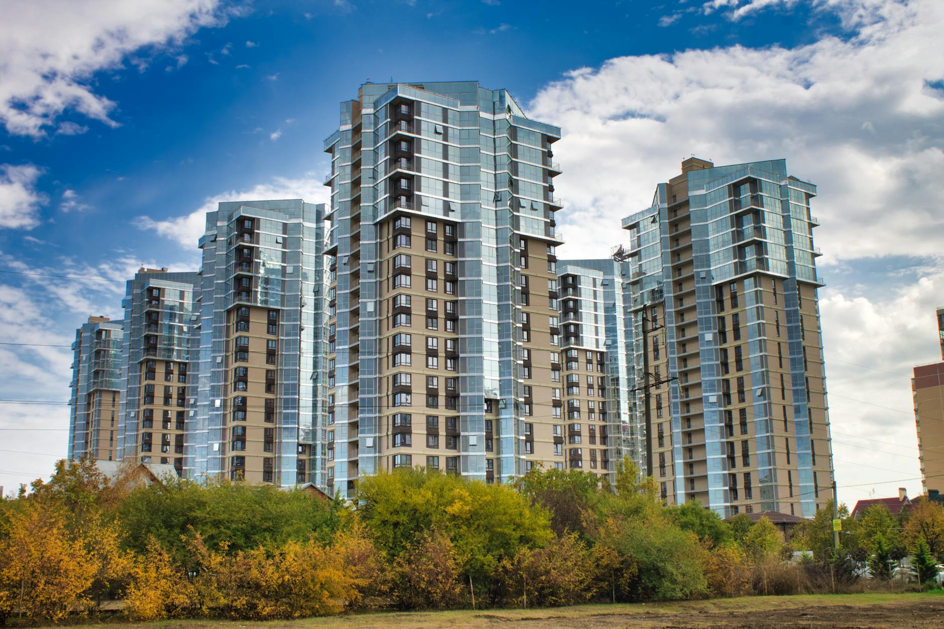 Modern residential skyscrapers with reflective glass windows.